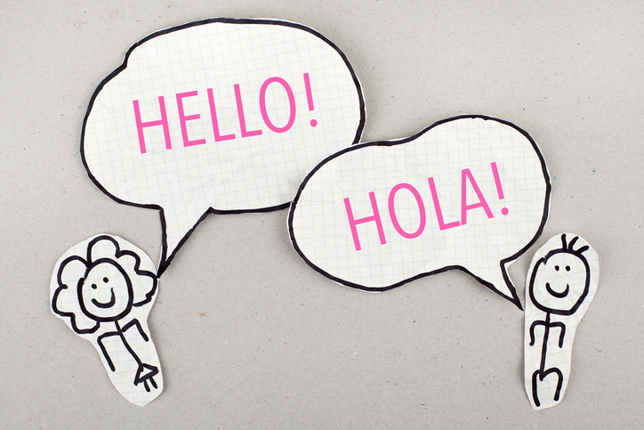 stick figures, one saying Hello in speech bubble, the other saying Hola in speech bubble for article on dual-language immersion