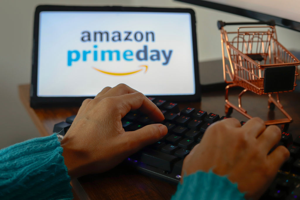 In this photo illustration, a person types near the Amazon Prime Day logo displayed on the screen of a tablet. Used for a story titled "5 takeaways from Amazon Prime Day advertising"