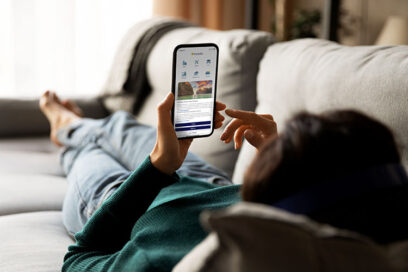 Woman on couch looking at her phone