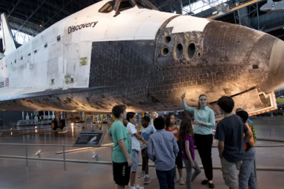 Astronomy educator Shauna Edson leads students through the Smithsonian’s National Air and Space Museum. The Space Shuttle Discovery behind them is currently on display at the Stephen F. Udvar-Hazy Center in Chantilly, Va. In 2012, NASA transferred Discovery to the Smithsonian after a delivery flight over the nation's capital.