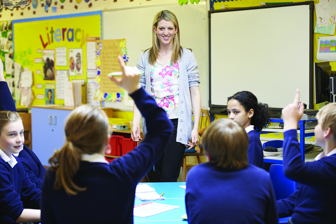 Teacher answering questions from class