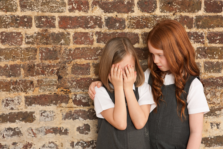 Girl comforting her friend for article on peer-to-peer support