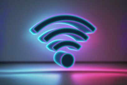 3D Wifi icon illuminated by neon lights on multicolor background.Digital composite for article on E-rates