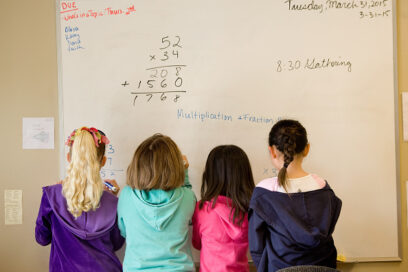 TRABUCO CANYON, CA - MARCH 31: Children gather next to the whiteboard while they work math problems in Veronica Harth's class at LePort Montessori school in Irvine. She teaches combined grades 1-3. for article on thinking classrooms