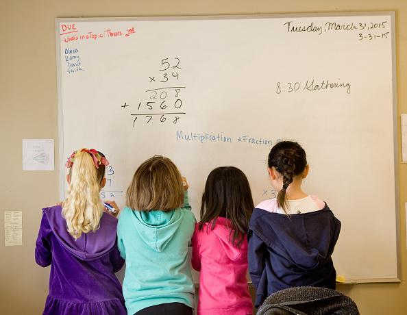 TRABUCO CANYON, CA - MARCH 31: Children gather next to the whiteboard while they work math problems in Veronica Harth's class at LePort Montessori school in Irvine. She teaches combined grades 1-3. for article on thinking classrooms