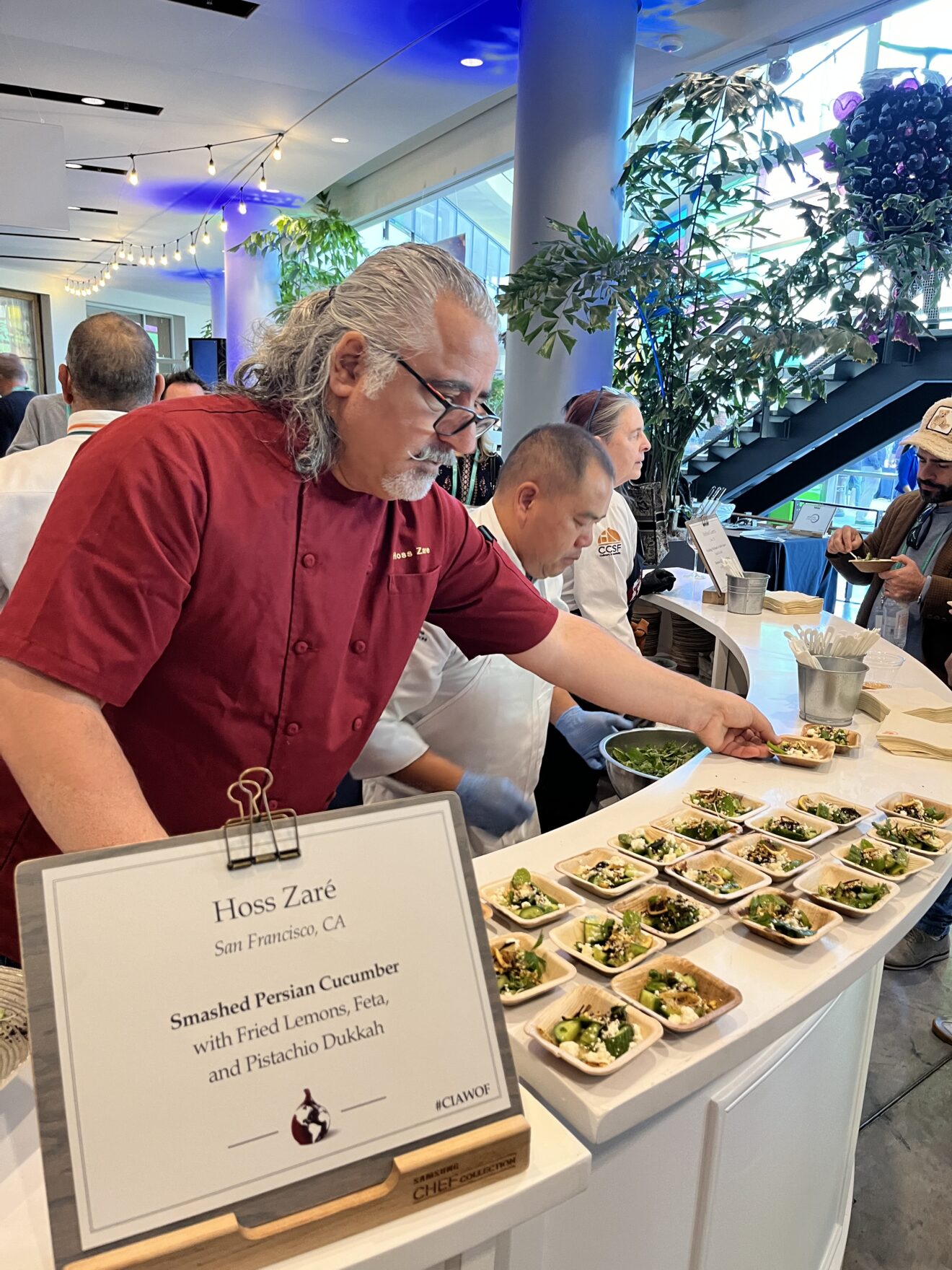 Chef Hoss Zare serves smashed Persian cucmbers with fried lemons, feta and pistachio duka at the World Marketplace.