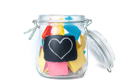 clear jar filled with colorful slips of paper for article on student questions in math for education